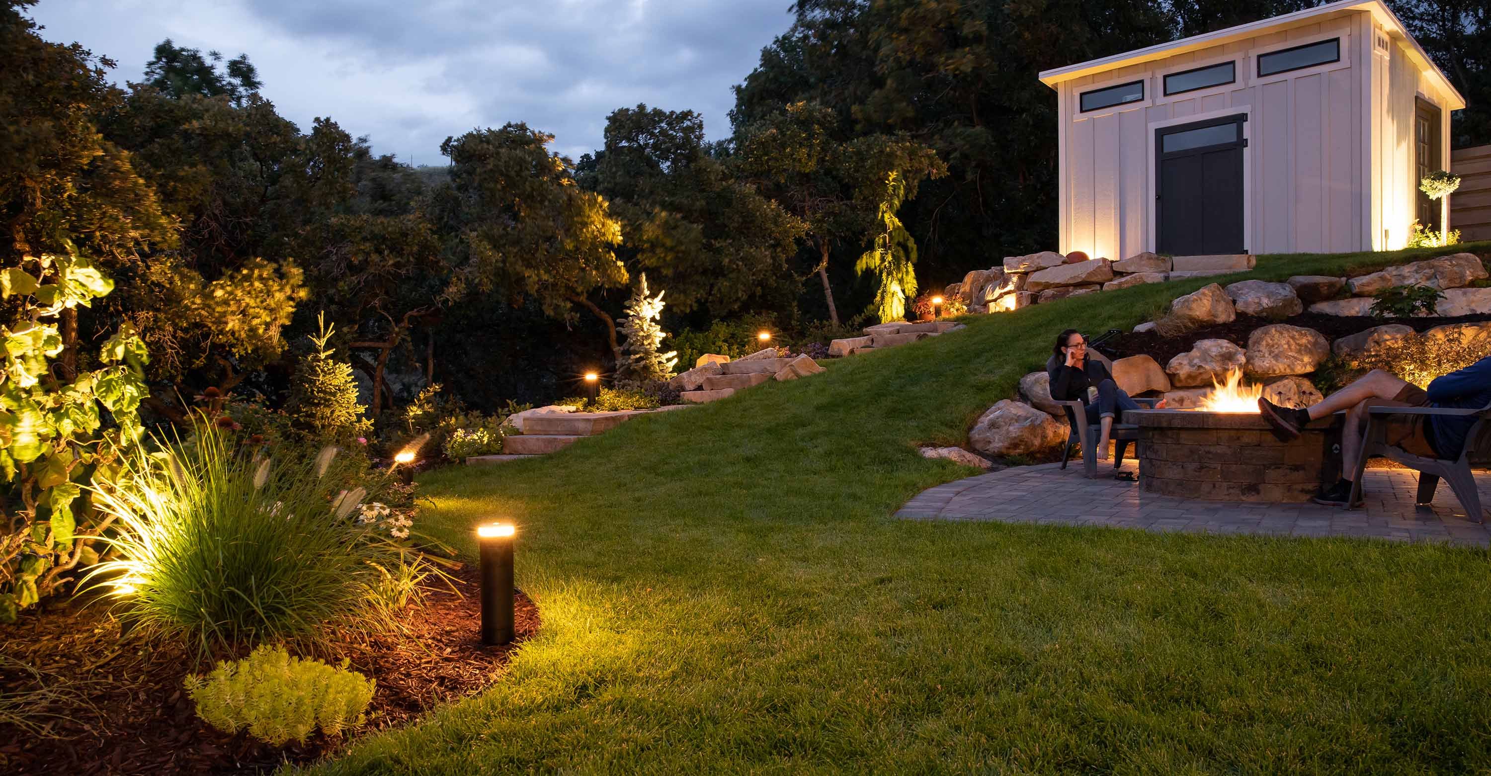 yard at dusk with episode bollard speakers and lighting