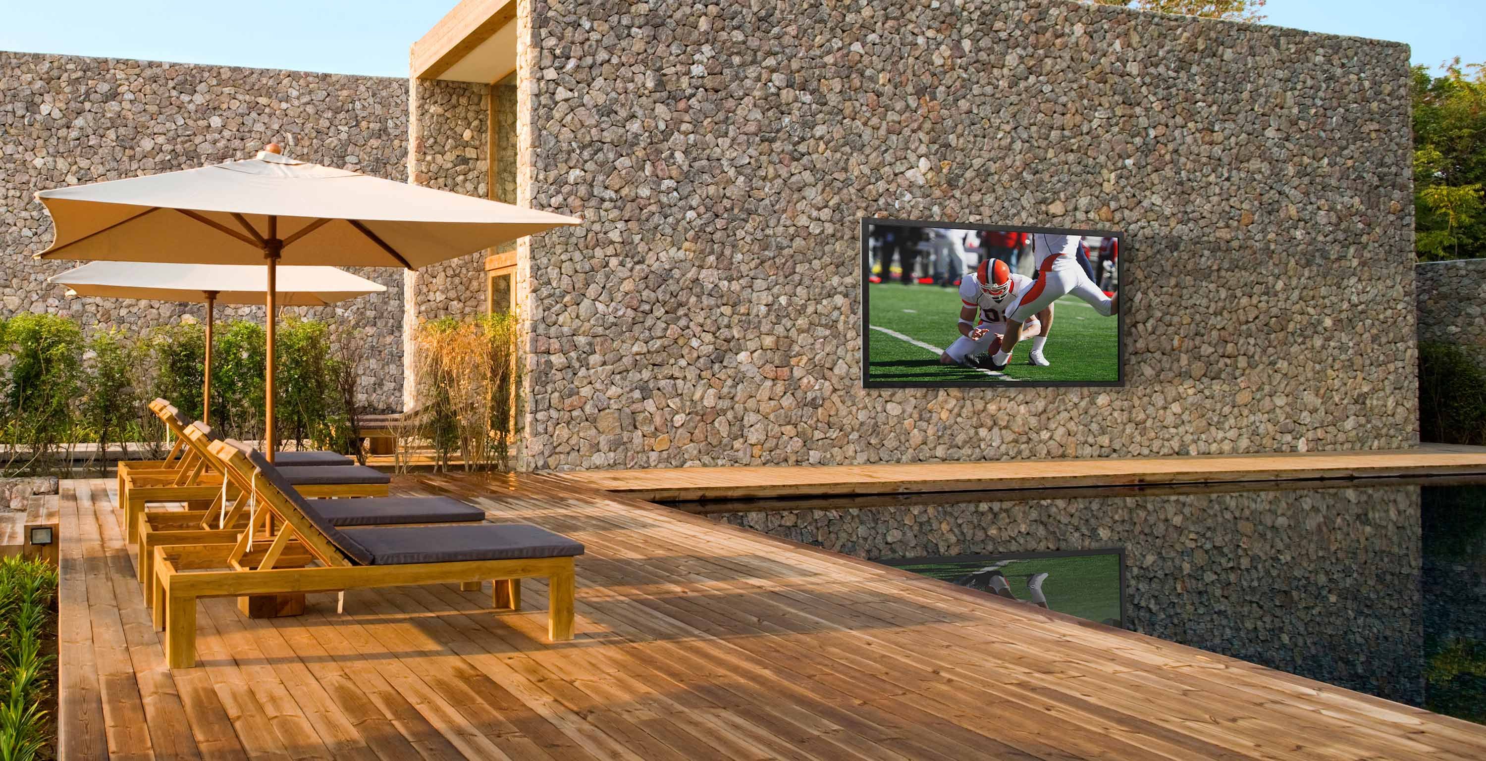 pool area with a home covered in rocks